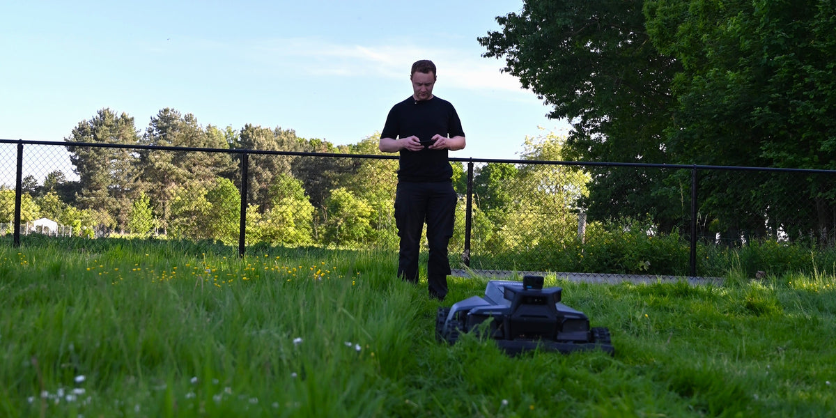 Man in a workshop with a large lawn mower