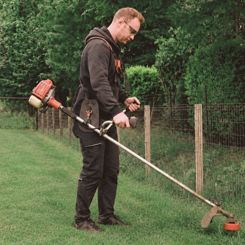 Man using a string trimmer in a garden with text overlay